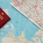 Flat lay of a passport and map, symbolizing travel adventure and exploration.